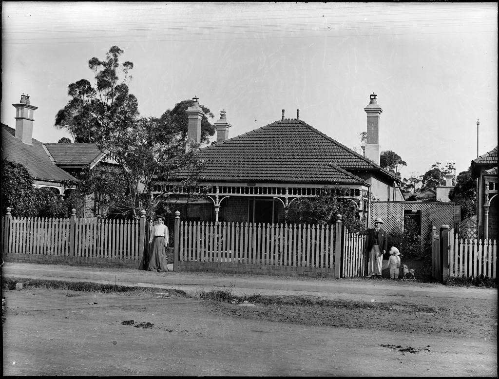 Suburban brick and tile house with a picket fence