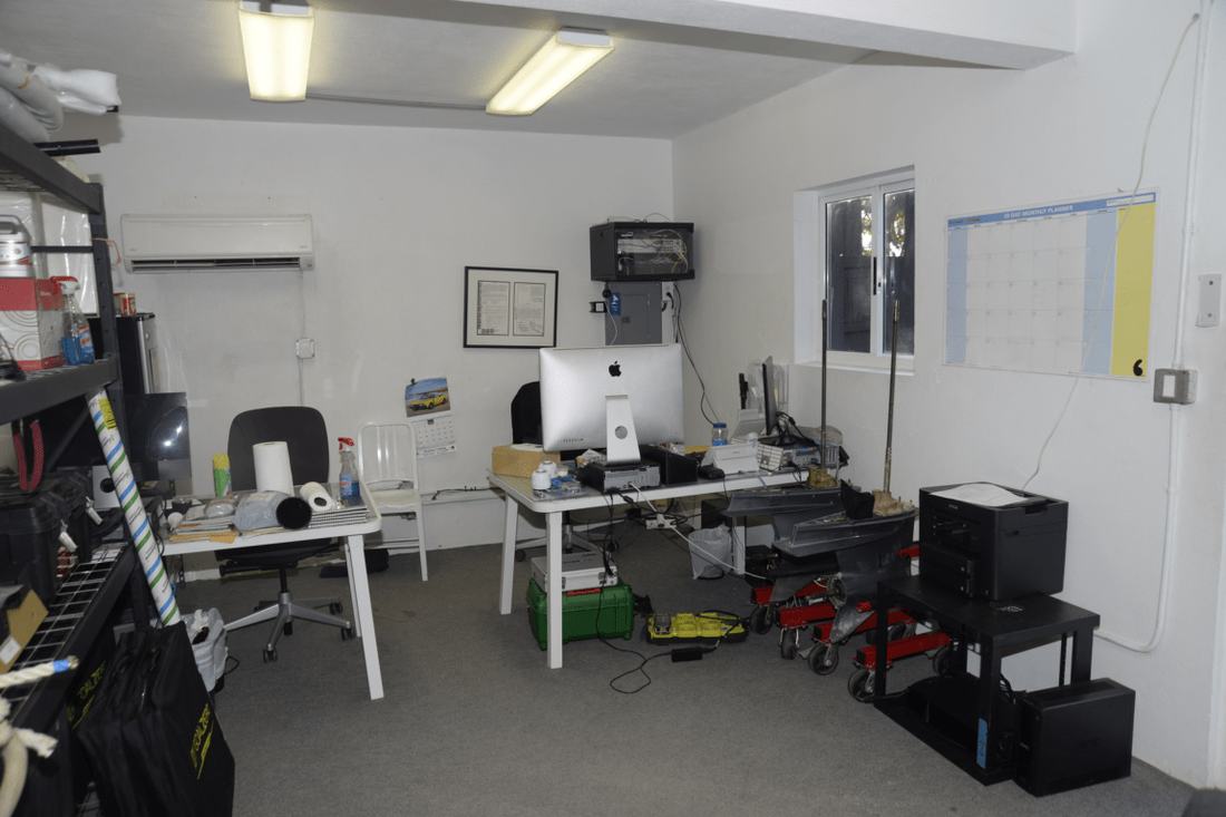 Office workspace with a calendar on the wall