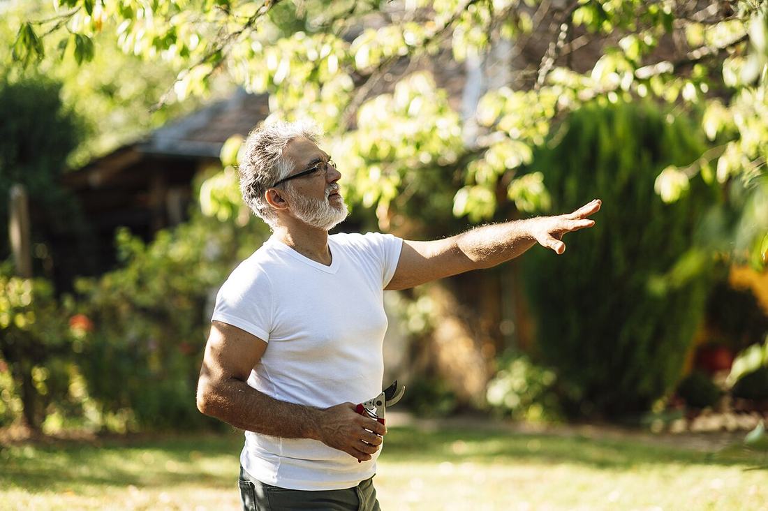 Senior man enjoying a sunny day in the garden
